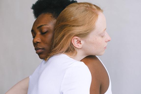 Young women hugging. 