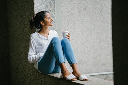 Person smiling and reflecting.